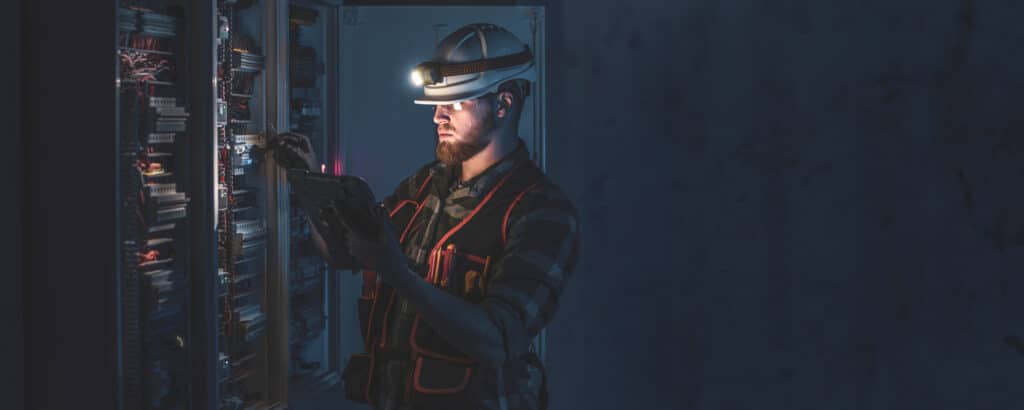 Burke Plumbing and Heating technician inspecting system control panel during service