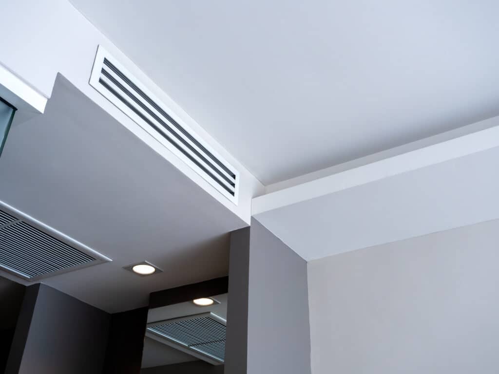 Ceiling-mounted HVAC air vent installed by Burke Plumbing & Heating in a modern residential interior.