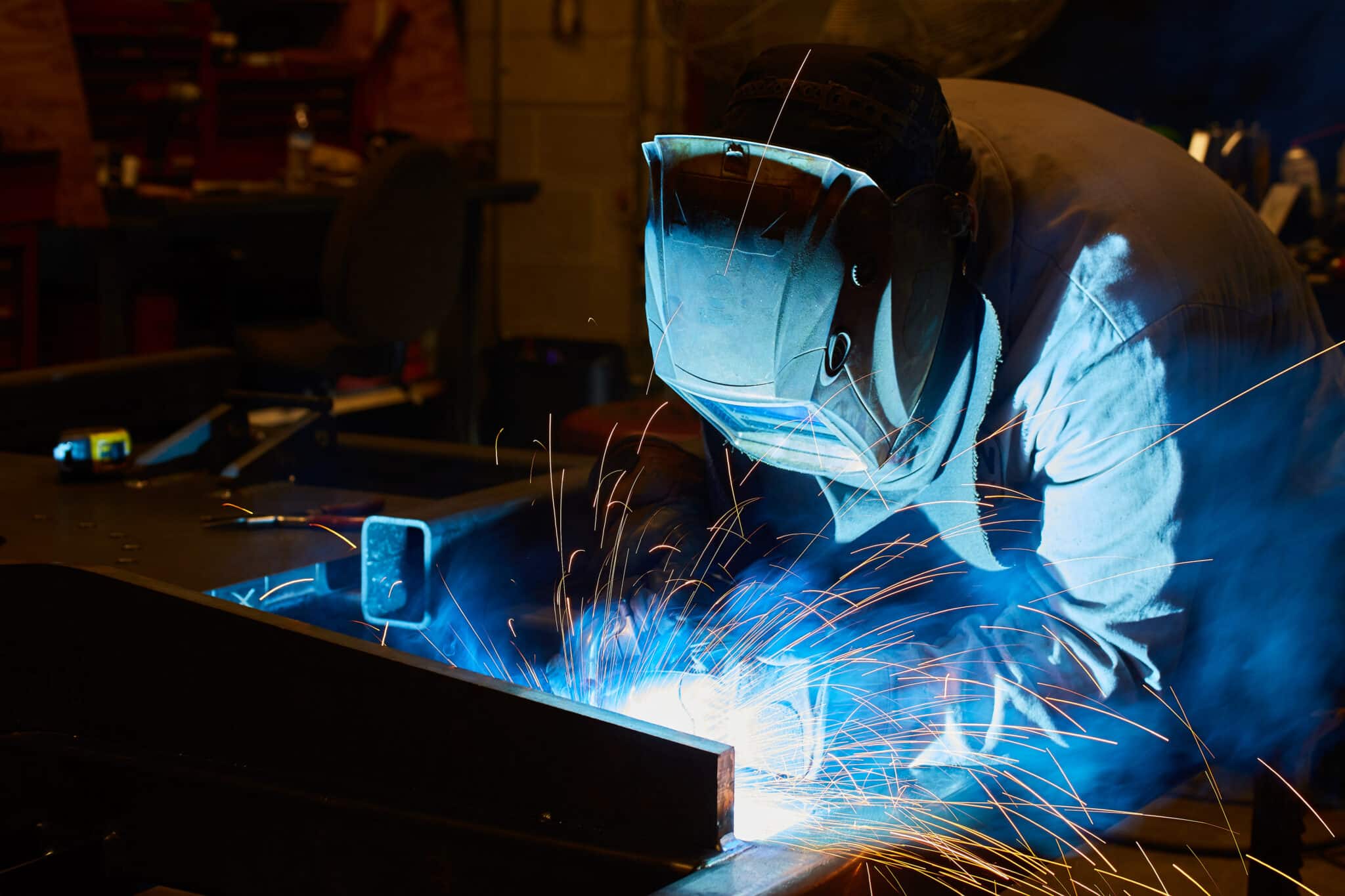 Welding helmet sparks of orange, Certified welding specialists.