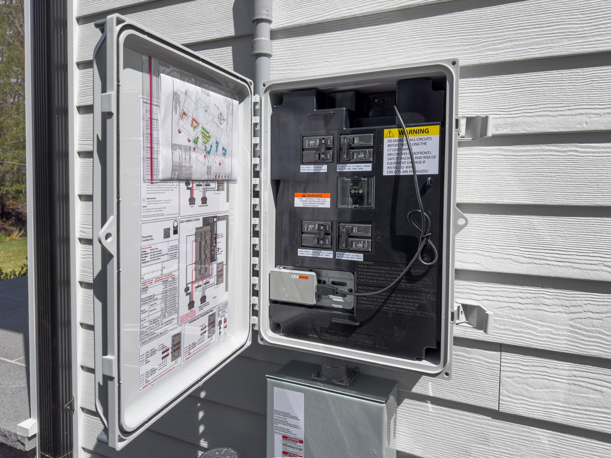 Electrician performing scheduled electrical maintenance on a solar power connection panel.